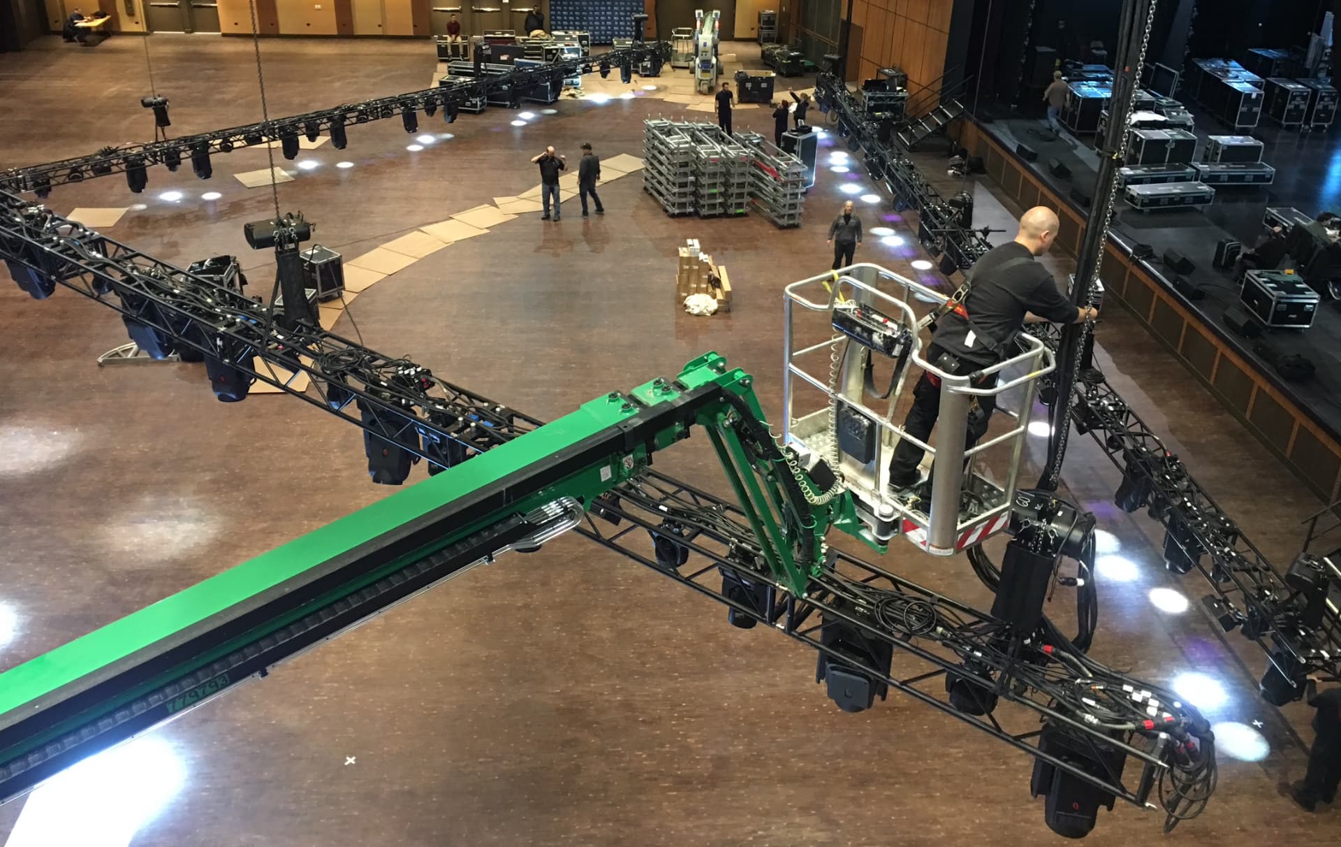 Lighting truss loaded with moving heads staged for rigging in a ballroom