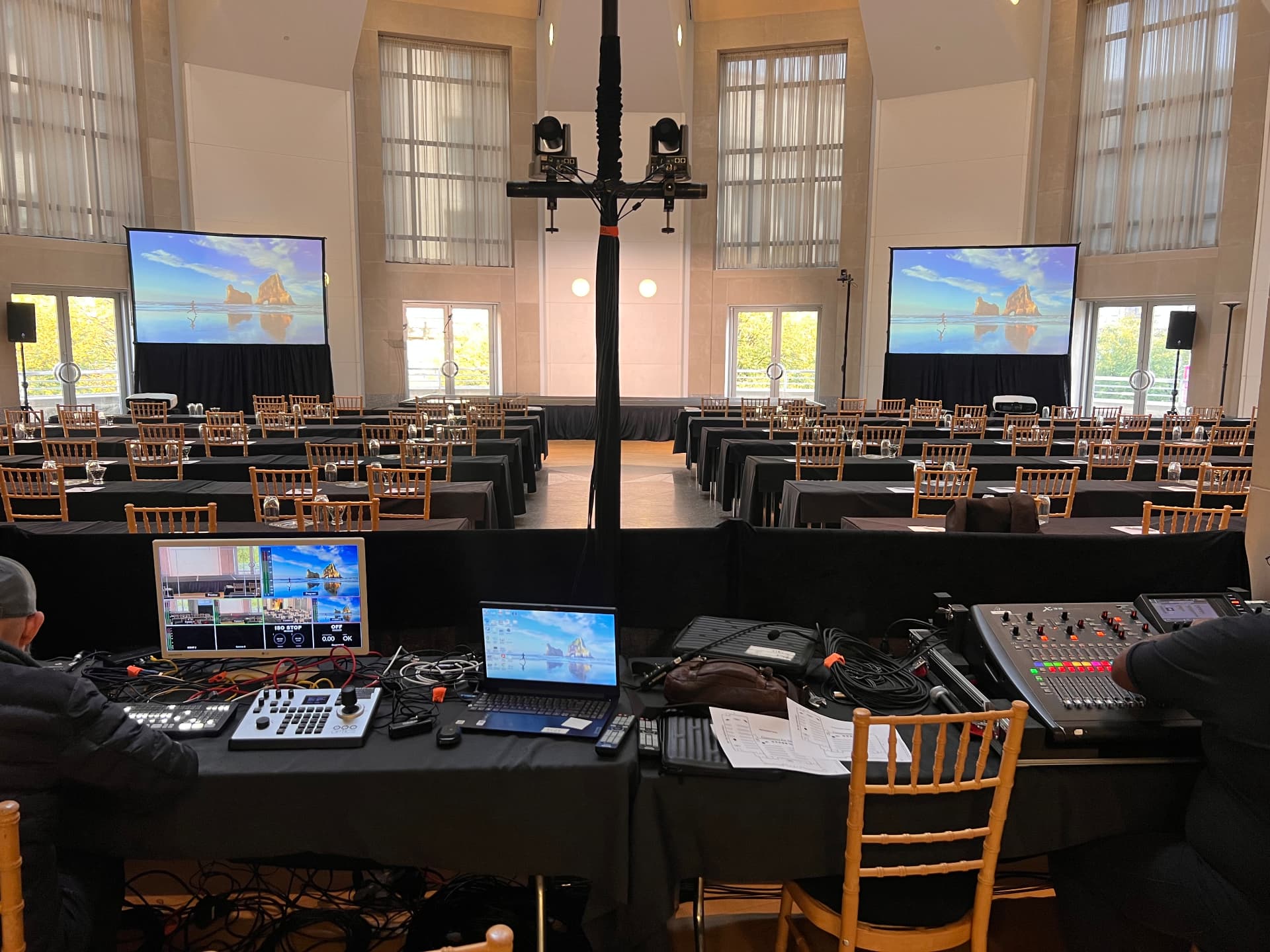 Front of house video switcher, laptop and digital audio console at a conference