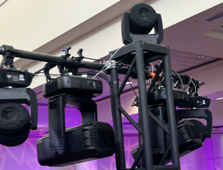 Moving head lighting fixtures rigged on black box truss