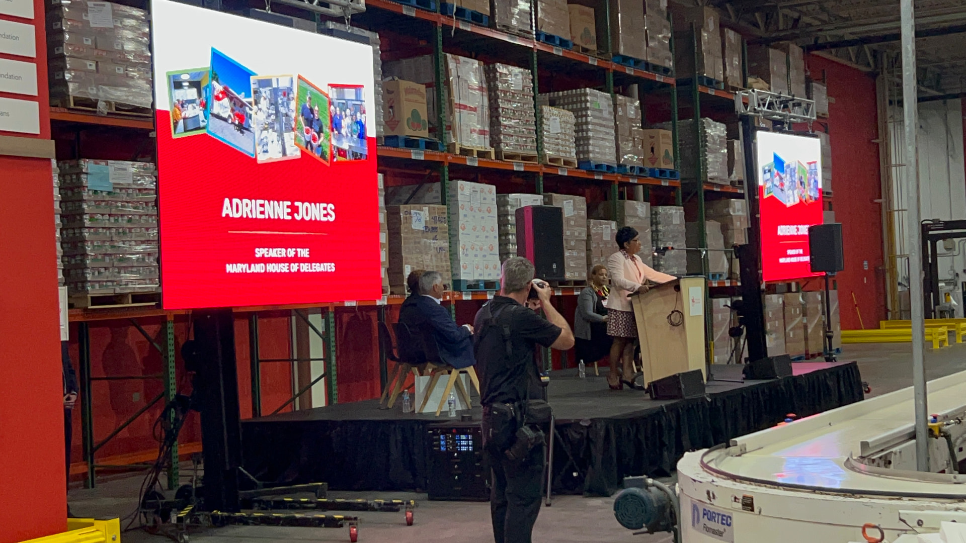 Dual LED screens and line array speakers at a corporate speaking event